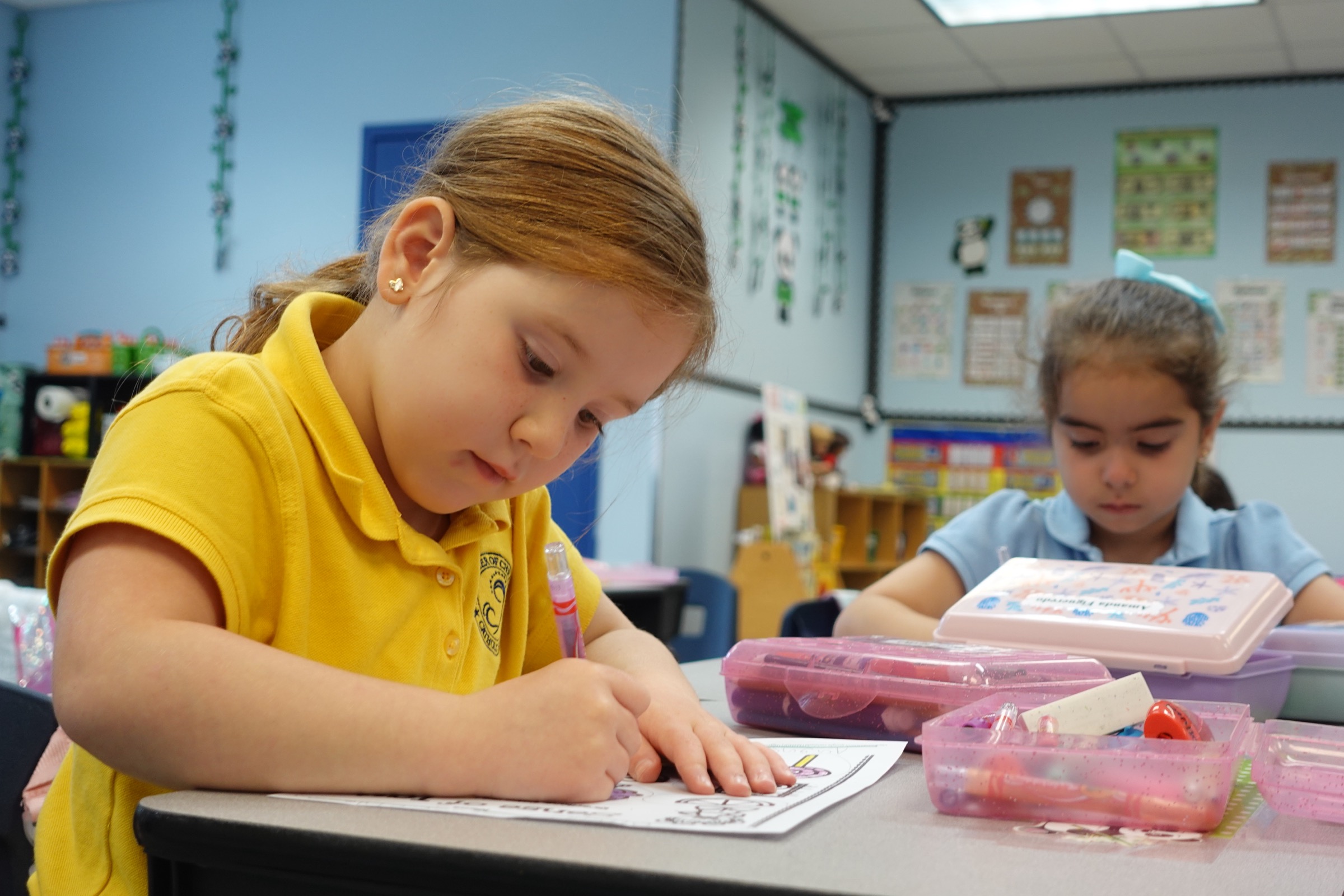 Elementary students writing in the classroom